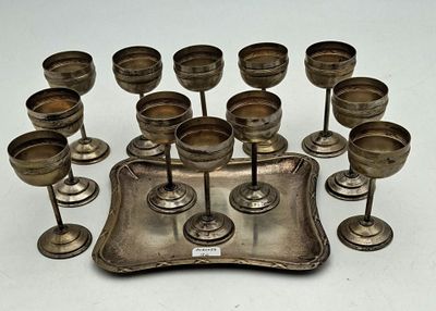 a silver tray with a bunch of wine glasses on it