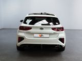 the rear end of a white car in a white room