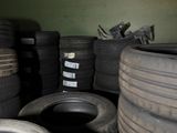 a lot of tires that are stacked up in a room