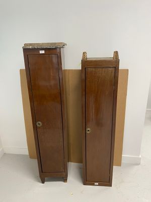 two wooden cabinets in the corner of a room