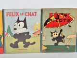 three children ' s books are lined up on a white surface
