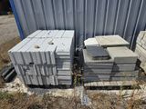 several stacks of concrete blocks stacked on top of each other in front of a building