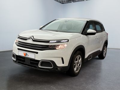 the white citrole suv is parked in a showroom