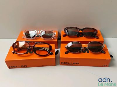 two pairs of sunglasses sitting on top of a box on a table
