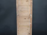 an old wooden door with no glass on it in front of a black wall