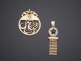 a gold pendant with a blue stone and a gold chain