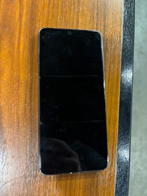 a cell phone that is sitting on a wooden table