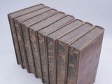 six books are stacked on top of each other on a white surface