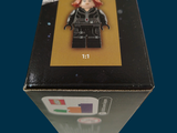 a box with a lego figure in it on a table