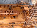 a wooden model of a ship on display in a museum