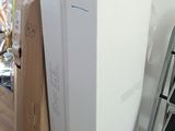 a white refrigerator sitting in the middle of a room next to a ladder