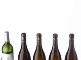 several bottles of wine are lined up on a table