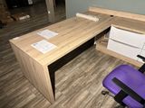 a wooden desk with a purple chair in front of it