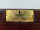 an image of a brass plate on a wooden table