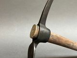 a hammer with a wooden handle on a gray surface