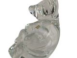 a glass figurine of a woman with a hat on her head