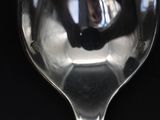 a close up of a wine glass with a reflection of a person in it