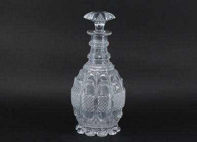 a clear glass vase sitting on top of a black table