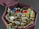 a purple box filled with lots of jewelry on a table