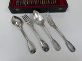 five spoons and two forks in a red box