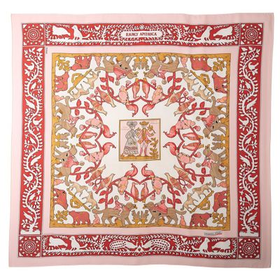 a pink and white square scarf with a floral design on it