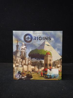 une image représentant une boîte du jeu de société « Origins » posée sur une surface noire