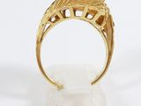 a close up of a gold ring on a white surface
