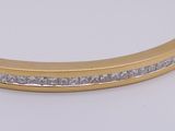 a close up of a gold bracelet with diamonds on it