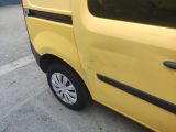 a small yellow van parked on the side of the road