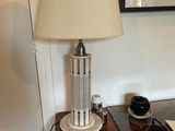 a lamp that is sitting on a table next to a picture