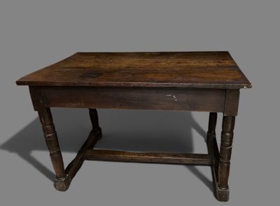 an old wooden table with a drawer underneath it on a gray surface