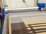 a picture of a machine cutting a piece of wood