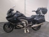 bmw motorcycle parked in a clean room with a checkered floor