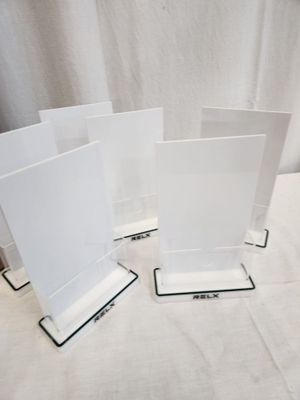 three clear acrylic stands on a table with a white background
