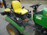 a picture of a lawn mower parked on the side of the road