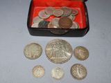 a red box filled with silver coins on a table