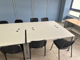 a white table with four chairs around it in a room