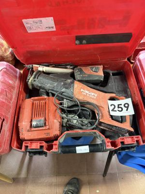 a red tool box with tools in it and a person standing next to it