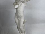 a statue of a little girl holding a flower