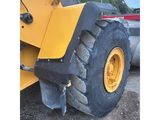 a picture of a large wheel loader parked in a lot