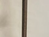 a metal pole with a metal object on top of it