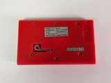 a close up of a red electronic device on a white surface