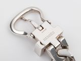 silver metal bracelet with a clasp on a white surface