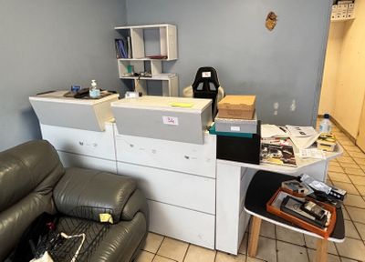a room with a couch, a desk, and a printer