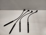 a set of four black electrodes sitting on top of a white surface