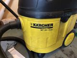 a yellow and black vacuum on the floor in a room