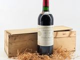 a bottle of wine sitting next to a wooden box