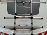 the back of a white truck with a rack attached to the back of it