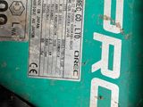 a close up of a green mower with a number plate on it