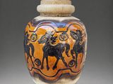an orange and black vase with a picture of a man riding a horse on it
